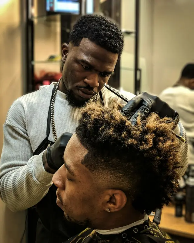A barber cutting a client’s hair